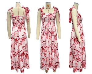 Detail view showing smocked square neckline and ribbon tie shoulder straps on floral maxi dress