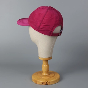 Close-up of magenta quick-dry baseball cap featuring adjustable metal buckle and breathable eyelets