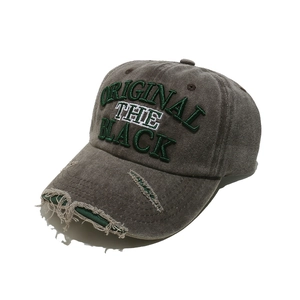 Detailed close-up of vintage washed grey cotton baseball cap with distressed brim details