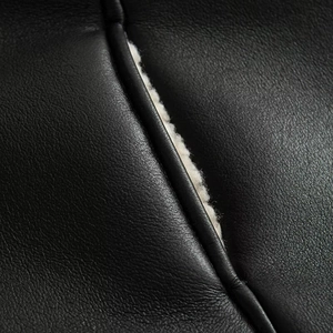 Detail shot of the contrast between premium black faux leather and soft white fleece lining