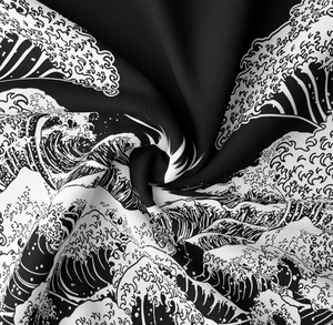 Macro detail of silky black and white fabric with Great Wave off Kanagawa print