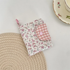 Floral canvas mini wallet with pink plaid flap and clasp shown in a cozy tea scene