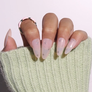 Short almond nude press-on nails with silver star patterns and elegant pink ring