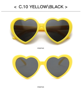 Detail of yellow heart-shaped sunglasses with black polarized lenses from a positive angle