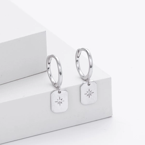 Detailed macro view of S925 silver star pendant earrings with white cubic zirconia
