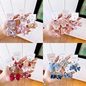 Collage of colorful fabric bow and flower hair ties for girls in various patterns