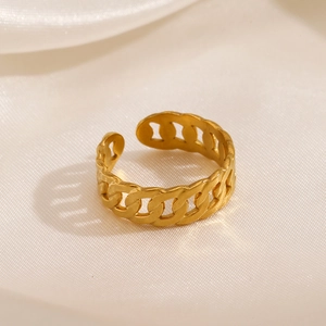 Minimalist gold cuban chain link open ring on white satin fabric background