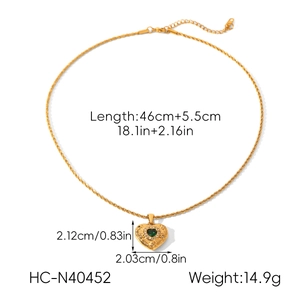 Detailed view of a gold heart pendant necklace with green zircon and size measurements