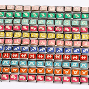 Macro shot of colorful enamel zodiac charm links for modular Italian charm bracelets