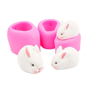 Detail view of pink silicone rabbit mold with finished white mousse cake figures