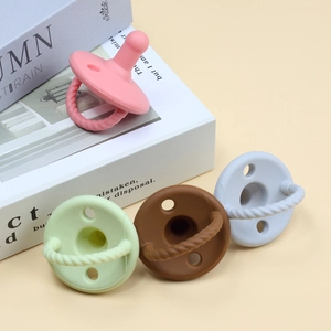 Multi-colored silicone baby pacifier teether set with spiral rings and breathing holes