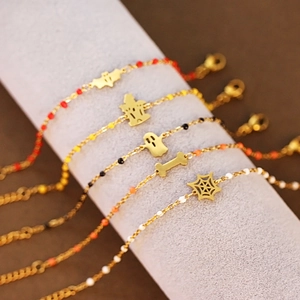 Macro shot of Halloween charm bracelets with bat, ghost, and spider web pendants