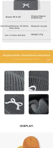 Detailed close-up of knit texture and white bow embroidery on a warm acrylic beanie