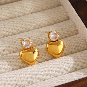 18K gold plated stainless steel heart earrings with zircon inlay on linen display