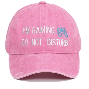 Close-up of I'M GAMING embroidery and gamepad icon on washed pink cotton baseball cap