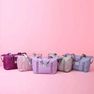 Large capacity foldable gym travel bags in various pastel colors on pink background