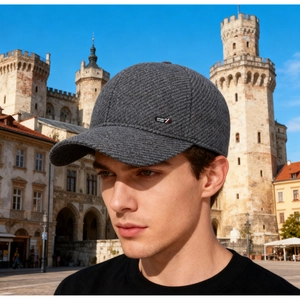 Detail of dark grey wool baseball cap showing twill texture and sport side label