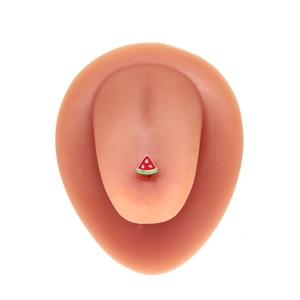 Macro view of watermelon slice tongue stud piercing on realistic silicone tongue model