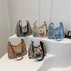Five vintage floral hobo bags in assorted patterns displayed on a white background