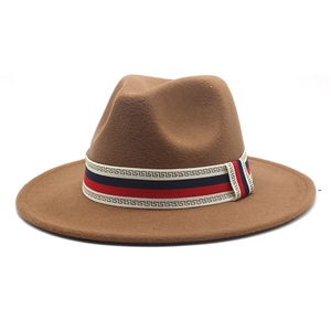 Detail of dark khaki wool fedora featuring a red, blue, and white Greek key ribbon band