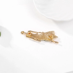 Elegant gold dancing girl brooch silhouette with textured finish and safety pin back