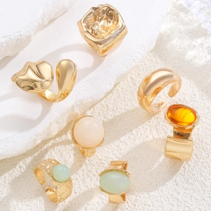 Detailed top view of a 6-piece vintage gold stackable ring set with colorful gemstones