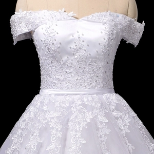 Elegant off-shoulder white lace wedding dress with pearls and sequin embroidery detail