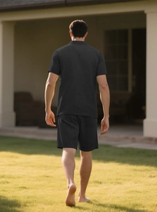 Outdoor back view of man wearing black knit button shirt and shorts beach set