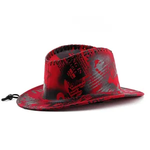 Detail of red cowboy hat with graffiti prints, decorative stitching and black chin cord