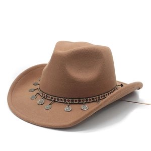 Classic tan felt cowboy hat with ethnic style ribbon and coin pendants on white background