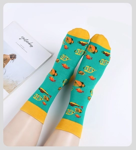 Detail of cotton crew socks featuring a colorful tropical fish pattern on sea blue