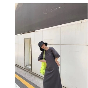 Minimalist charcoal grey long t-shirt dress with vibrant neon yellow mesh tote bag