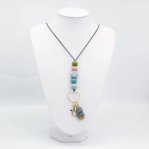 Colorful silicone bead lanyard necklace with gold keychain and tassel on model stand