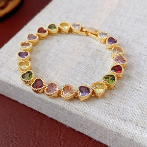 Macro shot of 18K gold plated bracelet featuring colorful heart-shaped zirconia stones