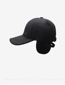 Close-up of winter grey wool baseball cap with earflaps and side metal brand logo
