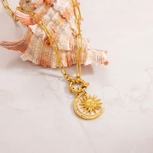 18k gold plated stainless steel sun and moon pendant necklace on white marble