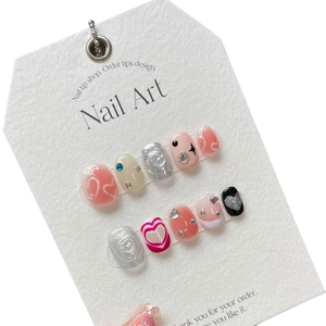 Handmade press-on nails with 3D heart designs, rhinestones, and pink metallic cat-eye finish