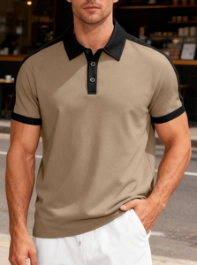 Detail of khaki polo shirt with black contrast collar and shoulder panels on street