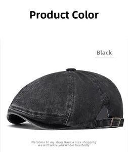 Macro view of washed black newsboy cap with metal adjustment buckle detail
