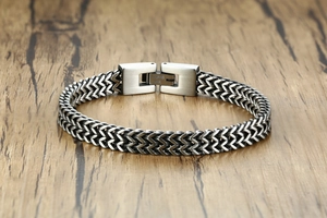Detailed macro view of silver steel dragon link bracelet with brushed metal texture