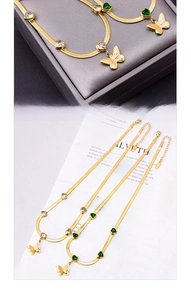 Close-up of golden blade chains featuring heart-shaped gems and butterfly pendants
