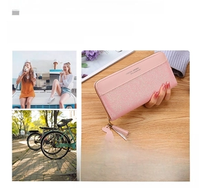 Pink long zip-around wallet with tassels and bow pendant featuring multiple storage layers