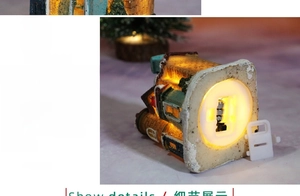 Detail of the LED resin house base with battery compartment and warm yellow light switch