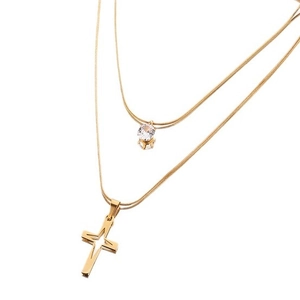 Double-layered gold snake chain necklace with zircon charm and cross pendant on white