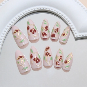 Vintage gold-trimmed floral press-on nails with 3D flower designs on almond shape