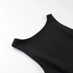 Detailed close-up of halter neckline and shoulder cut of black sleeveless mini dress