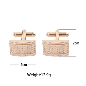 Detail of rose gold rectangular cufflinks with grid pattern and 2cm size markings