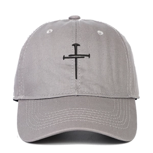 Close-up of black cross nails embroidery detail on gray canvas baseball cap crown