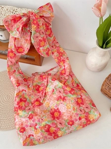 Floral fabric shoulder bag with oversized pink bow strap and romantic flower print