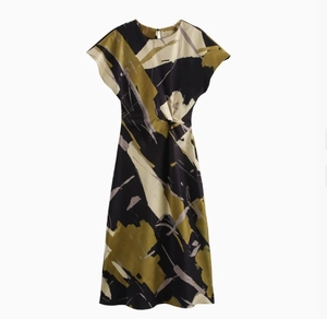 Detail view of a satin-textured midi dress with retro abstract floral print in dark green